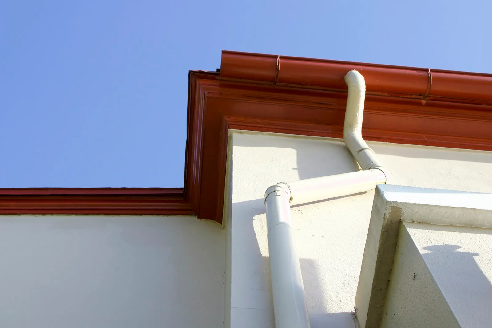 House gutters that need clearing of debris and moss