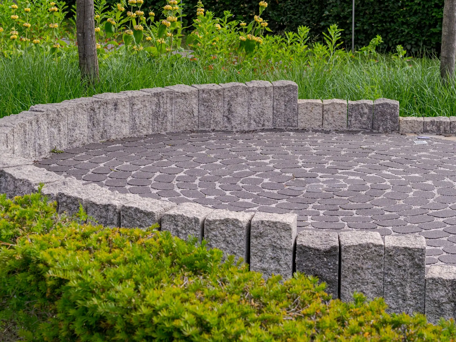 Clean stone patio with circular paving pattern